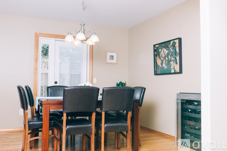 A dining room with a table and chairs.