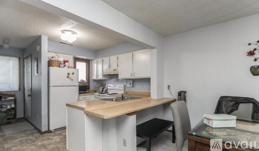 A kitchen with a table and chairs in the middle of the room.