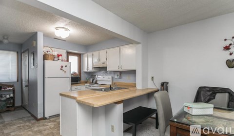 A kitchen with a table and chairs in the middle of the room.