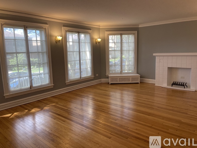 A living room with a fireplace and hardwood floors.