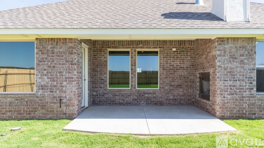 A house with a brick exterior and a covered patio.