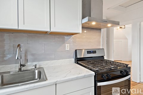 A kitchen with a stove and sink.