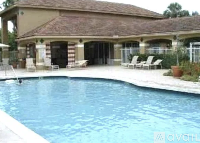 A large house with a pool in front.
