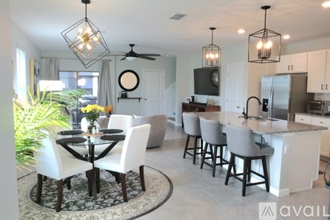A modern kitchen with a dining table set for four.