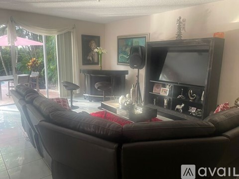 A living room with a large couch and a television.