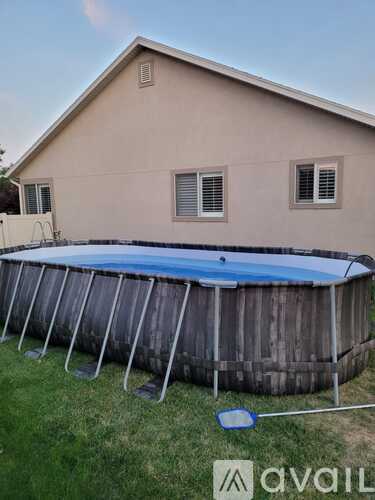 Above ground pool in a backyard.