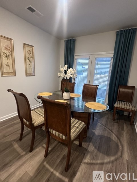 A dining room with a table set for four.