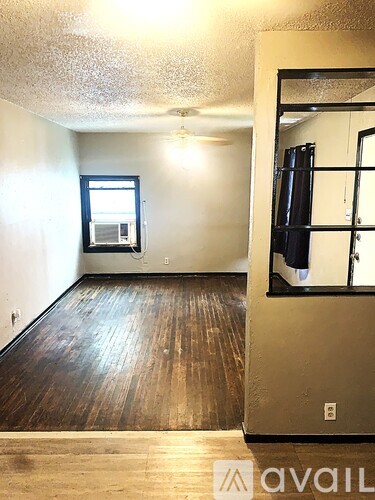 A room with wooden floors and a window.