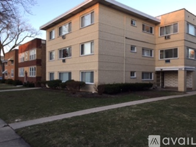 Apartment building with a grassy front yard.