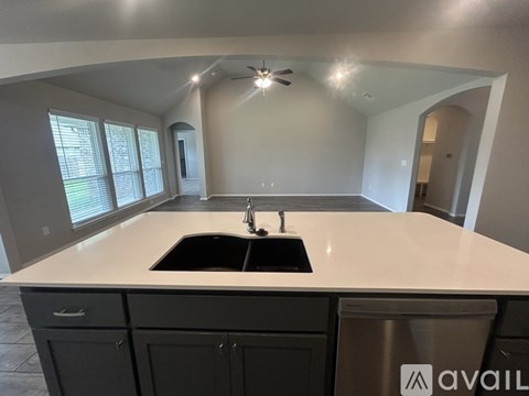 A modern kitchen with a sink and a window.