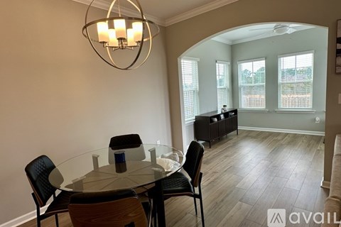 A dining room with a glass table and chairs.