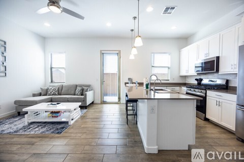 A modern kitchen with white cabinets and a central island.