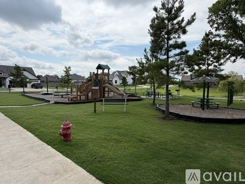 A playground with a slide and a fire hydrant.