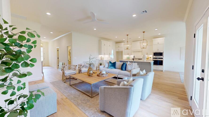 A modern living room with a grey sofa and a glass coffee table.