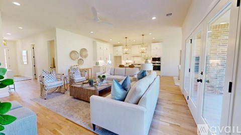 A kitchen with white cabinets and a bowl of fruit on the counter.
