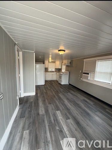 A room with wooden flooring and a white ceiling.