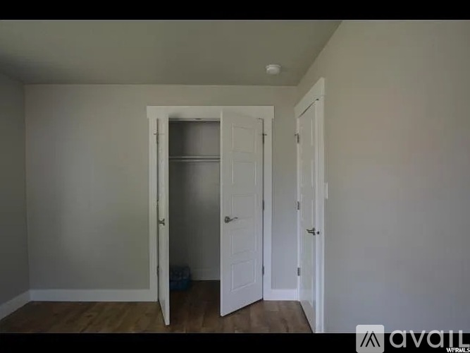 A room with a white door and a white wall.