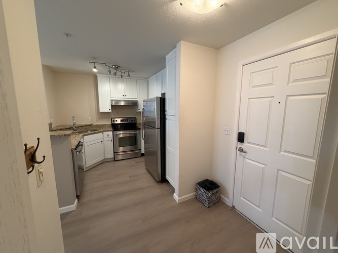 A kitchen with a refrigerator, oven, and microwave.