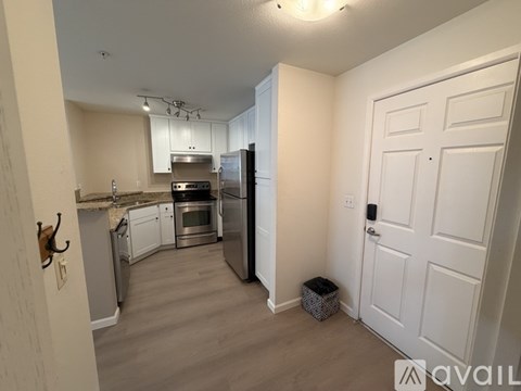 A kitchen with a refrigerator, oven, and microwave.