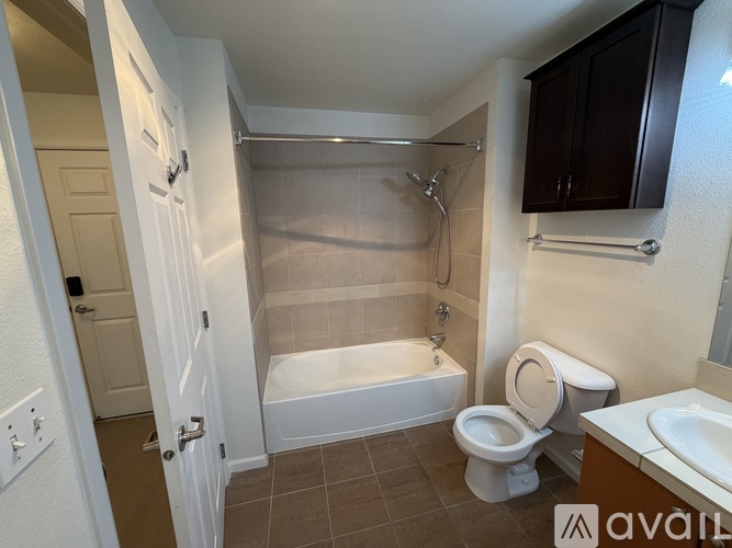 A bathroom with a toilet, sink, and bathtub.