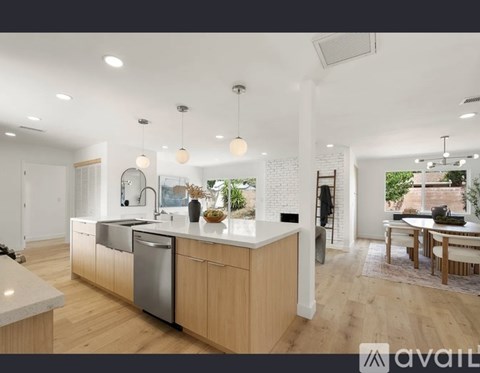 A modern kitchen with wooden cabinets and a large island.