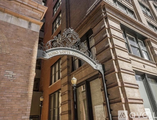 A building with a sign that reads "SOHO LOFTS" is shown.