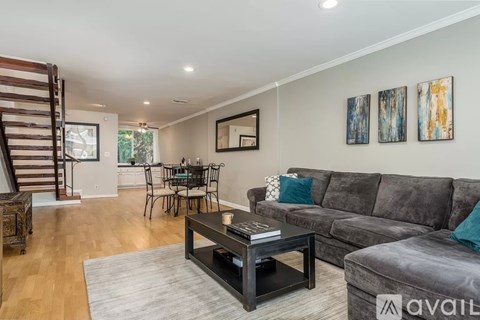 A living room with a grey couch and a coffee table.