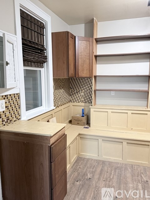 A kitchen with wooden cabinets and a countertop.