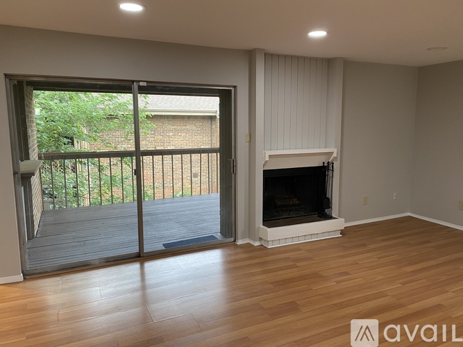 A living room with a fireplace and sliding glass doors.