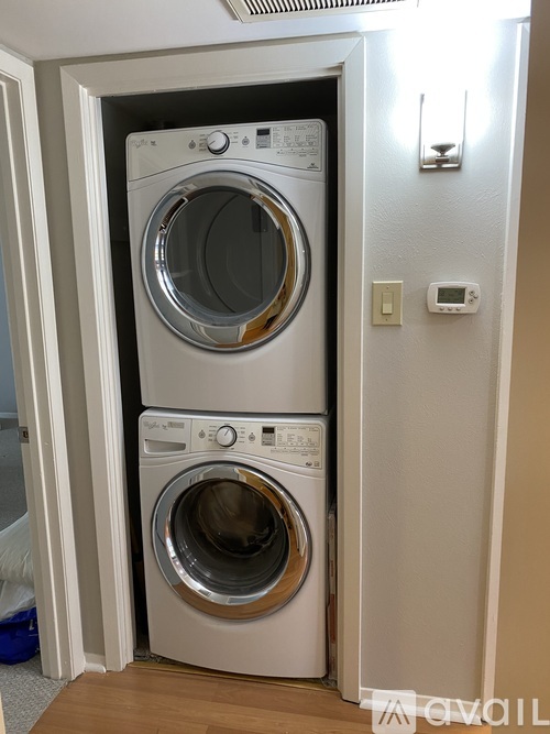 Two washing machines in a small space.