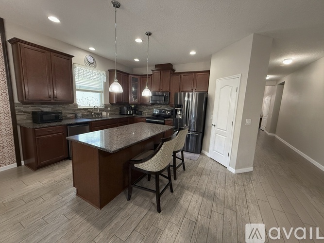 A kitchen with brown cabinets and a white door.