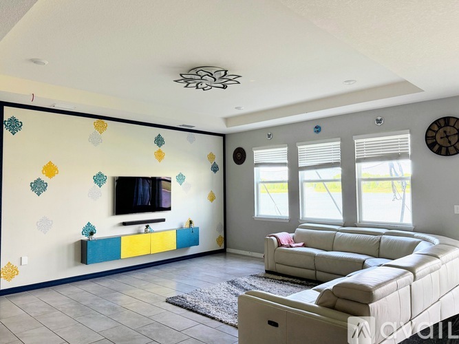 A living room with a white couch and a television.