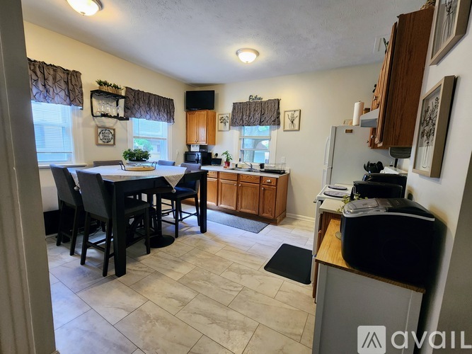A kitchen with a dining table and chairs.