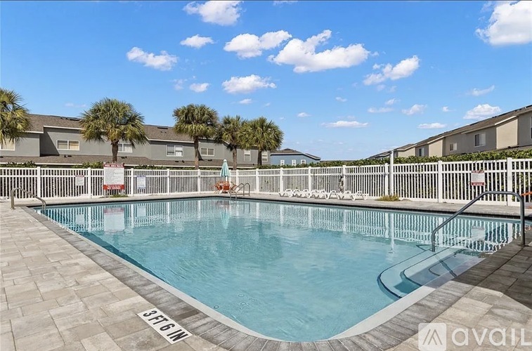 A pool surrounded by a fence with the text "AVAILABLE" on it.