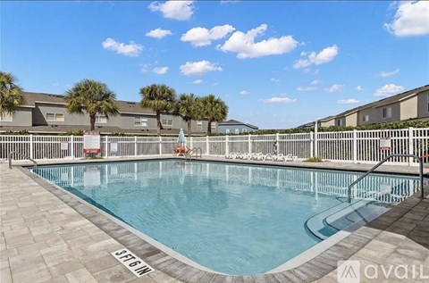 A pool surrounded by a fence with the text "AVAILABLE" on it.