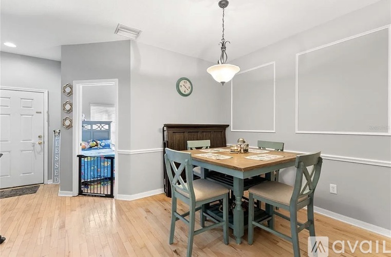 A dining room with a table set for four.