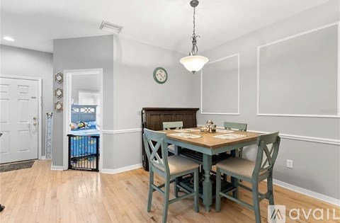 A dining room with a table set for four.