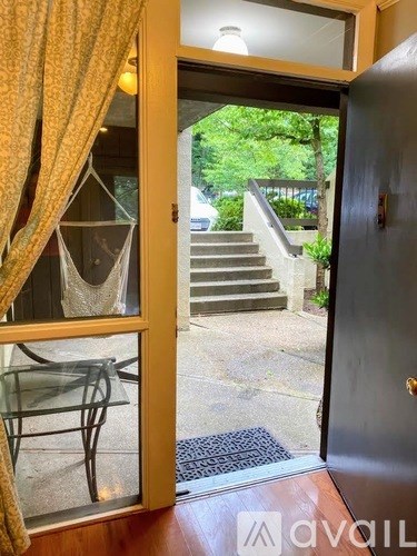 A view from inside a room looking out through a glass door to a staircase.