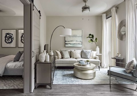 A modern living room with a grey and white color scheme.