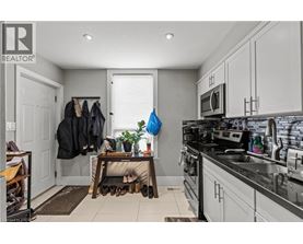 A kitchen with a black counter top and white cabinets.