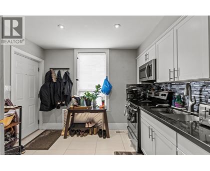 A kitchen with a black counter top and white cabinets.