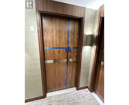 A wooden door with a blue tape across it.