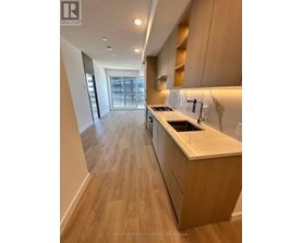 A kitchen with wooden floors and a countertop.