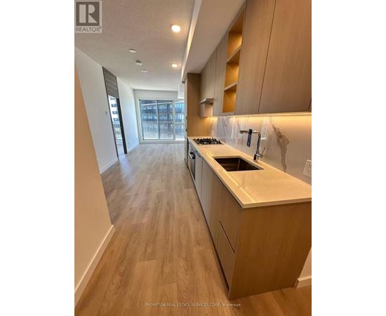 A kitchen with wooden floors and a countertop.
