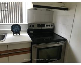 A black oven with a microwave on top of it.