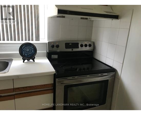A black oven with a microwave on top of it.