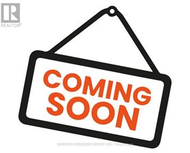 A sign that says "Coming Soon" is hanging on a wall.