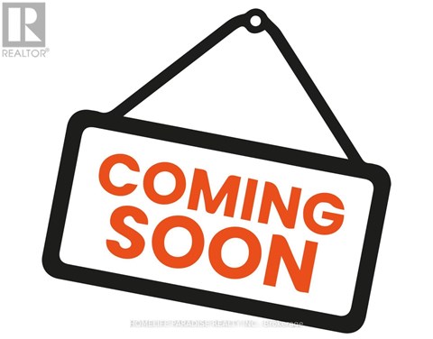 A sign that says "Coming Soon" is hanging on a wall.