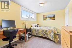 A bedroom with a bed, desk, and chair.