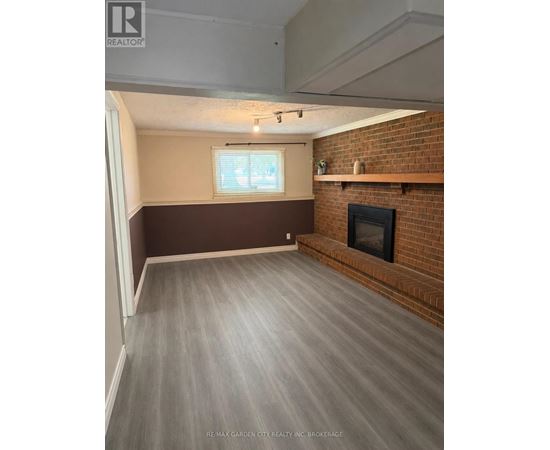 A room with a fireplace and a window.